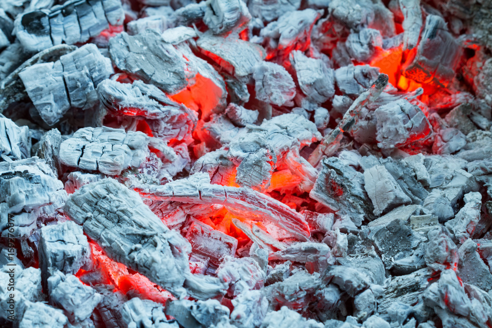 Closeup of smouldering coals, burning charcoal on dark. Ashes in the barbecue. Closeup of smouldering coals, burning charcoal on dark. Ashes in the barbecue.