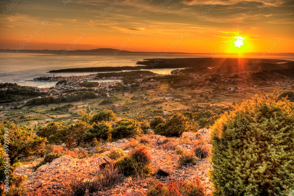 Fototapeta premium Sunset over the island and city of Rab in the Adriatic sea, Croatia