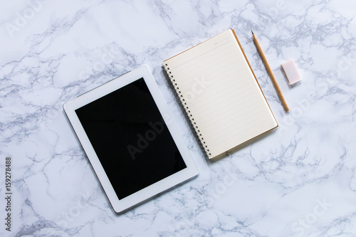 Modern mock-up flat lay of notebook and tablet on white marble texture background - Work space concept