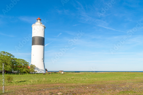The tall lighthouse Long Jan on the island Oland in Sweden, seen with part of the coastline in the background. Copy space.