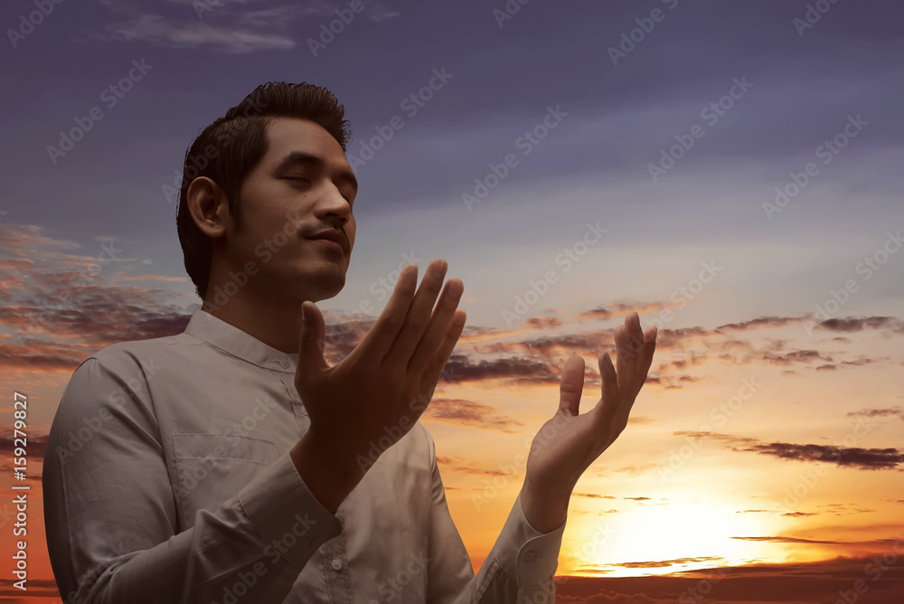 Religious asian muslim man praying to god