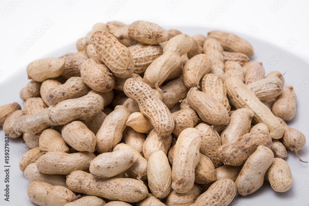Dried peanuts on white plate at on white background Dried peanuts on white plate at on white background