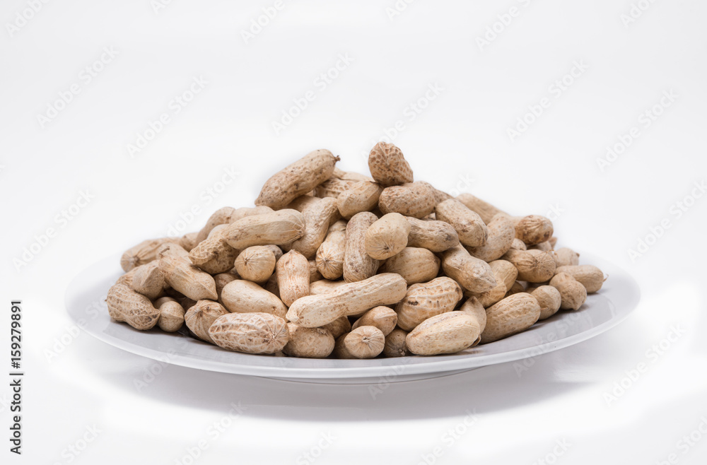 Dried peanuts on white plate at on white background Dried peanuts on white plate at on white background