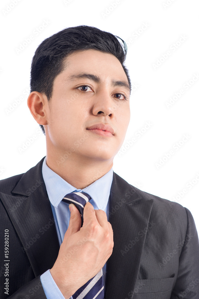 Portrait asian businessman adjusting his tie - closeup shot.