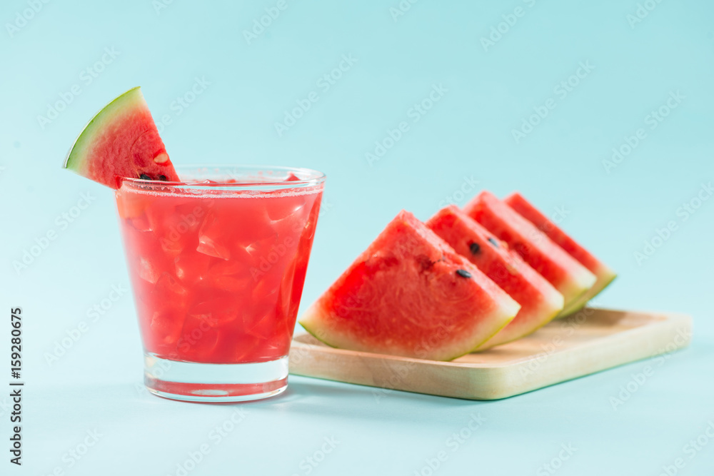 Glass of healthy watermelon juice in summertime on blue background. Glass of healthy watermelon juice in summertime on blue background.