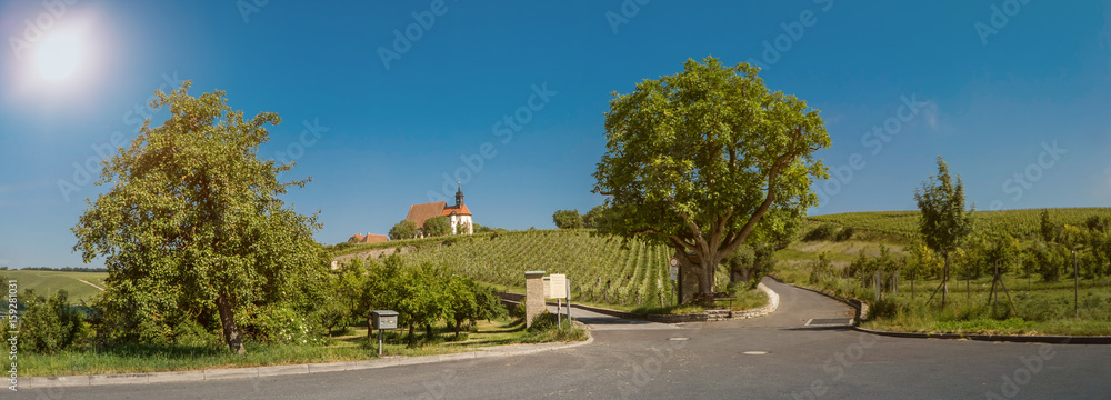 Panorama and sunny view to a bavarian church in the vineyards