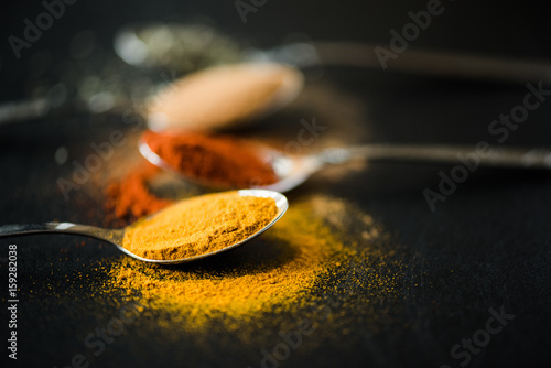 Fototapeta Naklejka Na Ścianę i Meble -  close up of various spices and herbs scattered in metal spoon