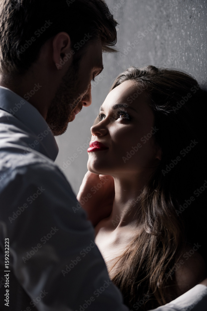 young sensual couple able to kiss while standing near the wall young sensual couple able to kiss while standing near the wall