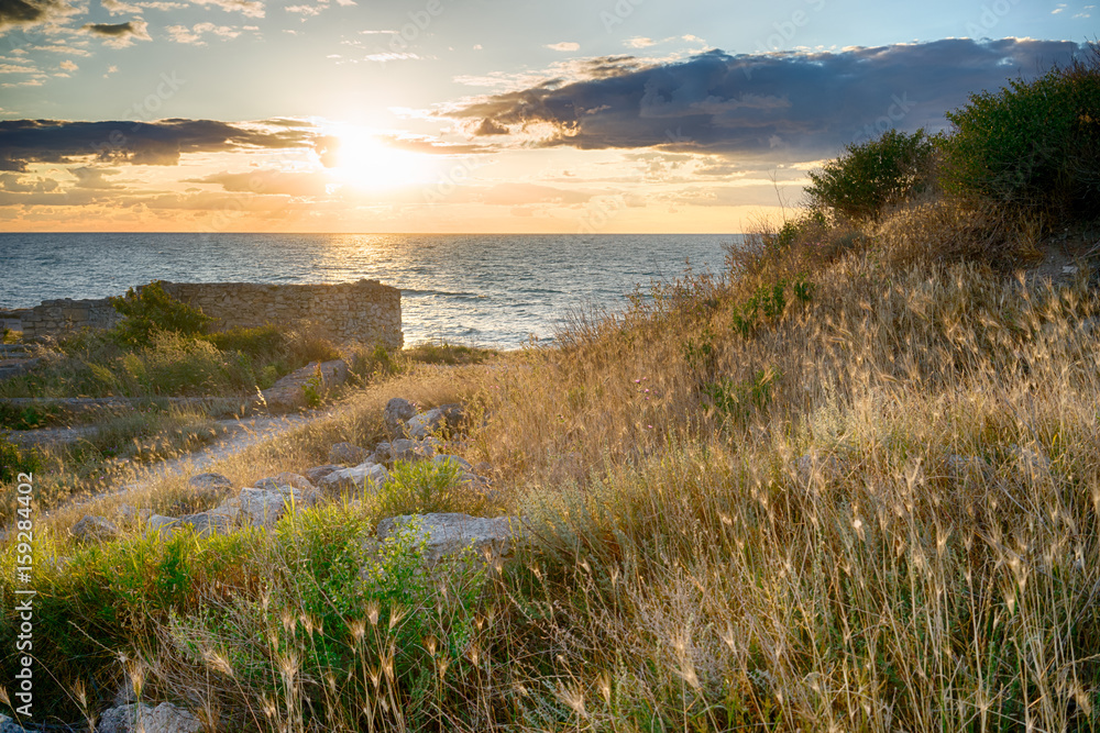 Sunset over the sea in the ancient city of Chersonesos Sunset over the sea in the ancient city of Chersonesos