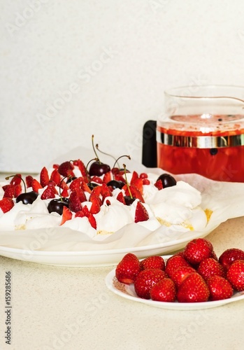 Cake Pavlova, strawberry, fruit ice tea on white.