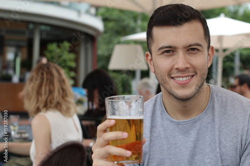 Happy man holding his cold refreshing beer