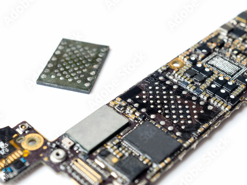 Close-up image of smartphone logic board removed flash storage (NAND) on white background photo