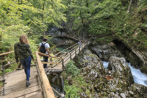 Bled, Slovenia - June 3, 2017: Tourists walking inside the Vintgar Gorge on a wooden path between Bled Lake and Bohinj Lake in Slovenia, Europe.