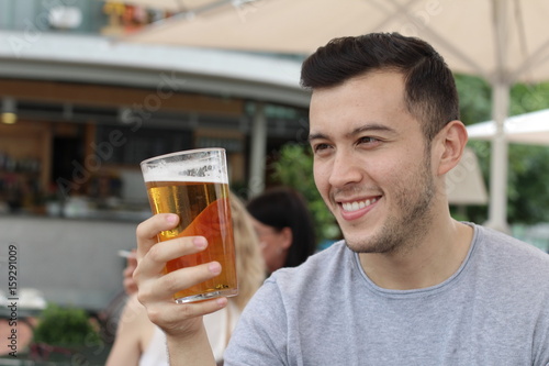 Man looking at his cold refreshing beer