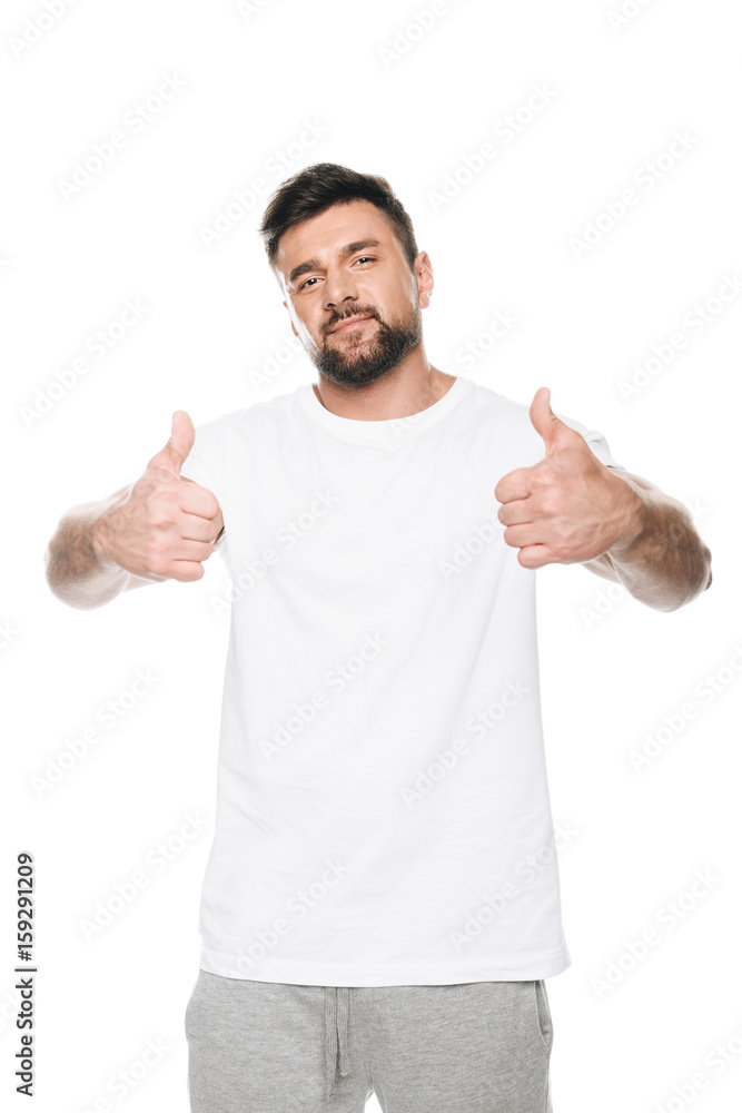 Portrait of man in white t-shirt gesturing thumbs up sign isolated on white Portrait of man in white t-shirt gesturing thumbs up sign isolated on white