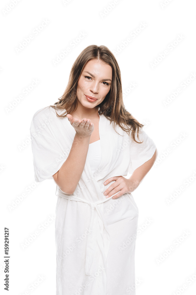 Portrait of young woman in white robe blowing a kiss at camera isolated on white Portrait of young woman in white robe blowing a kiss at camera isolated on white