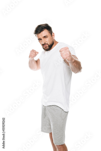 Portrait of handsome bearded man ready to fight isolated on white