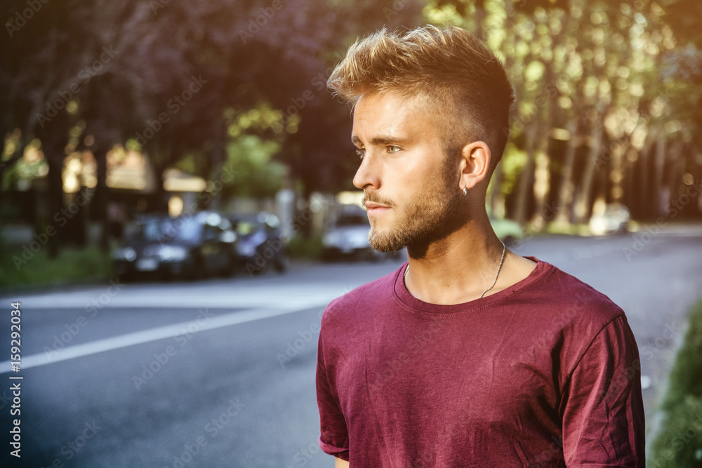 Good looking, blue eyed male model by city street, walking, looking to a side Good looking, blue eyed male model by city street, walking, looking to a side