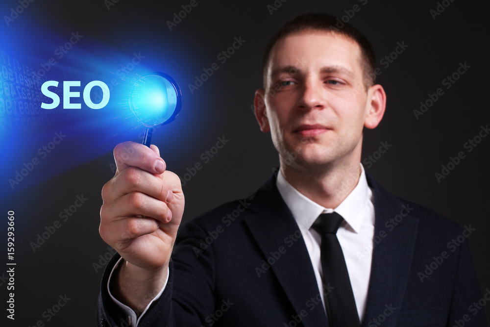 The concept of business, technology, the Internet and the network. A young entrepreneur working on a virtual screen of the future and sees the inscription: SEO The concept of business, technology, the Internet and the network. A young entrepreneur working on a virtual screen of the future and sees the inscription: SEO