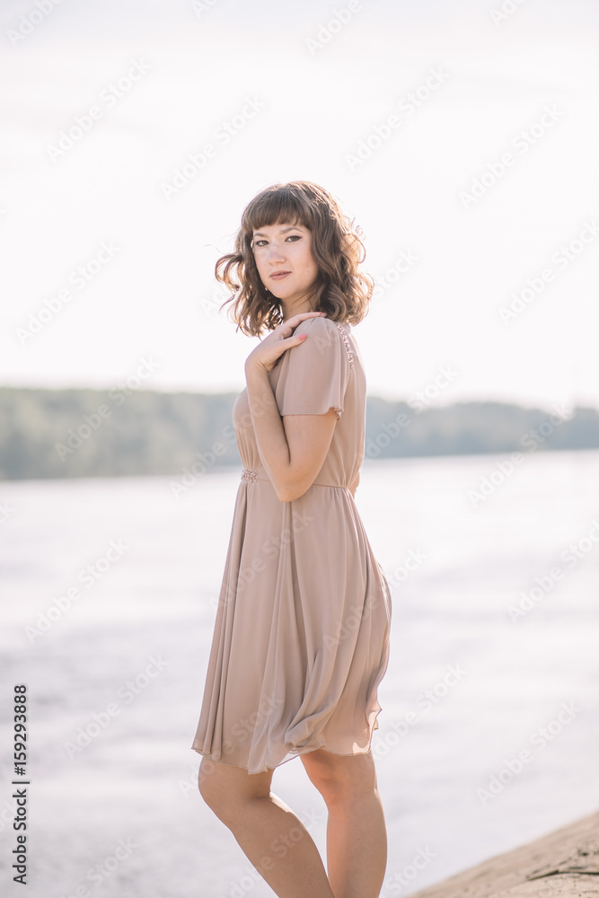 very beautiful, sexy, gentle, cute girl in beige dress standing on the banks of the river, nature, summer, smile very beautiful, sexy, gentle, cute girl in beige dress standing on the banks of the river, nature, summer, smile