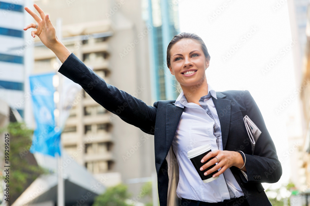 Portrait of business woman catching taxi Portrait of business woman catching taxi