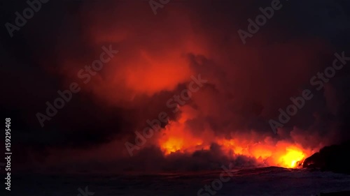 Lava flows into the ocean at night. Kilauea Volcano, Hawaii Big Island, USA.