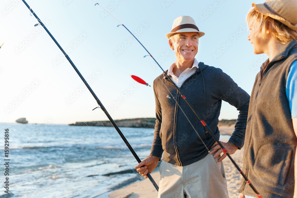 Senior man fishing with his grandson Senior man fishing with his grandson