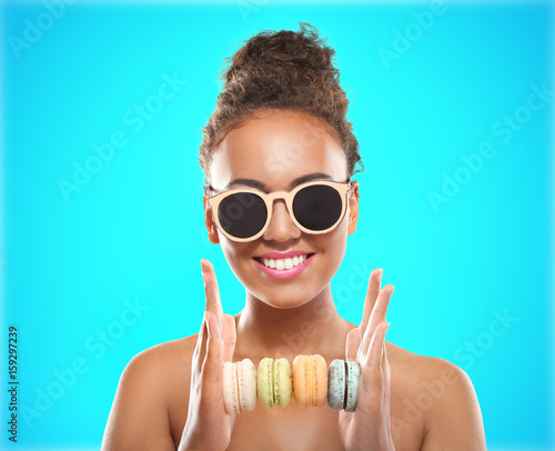 Young woman holding pile of...