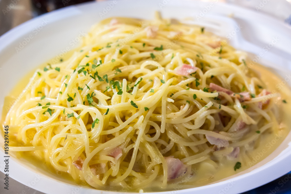 Spaghetti Carbonara served on white plate. Soft Focus.