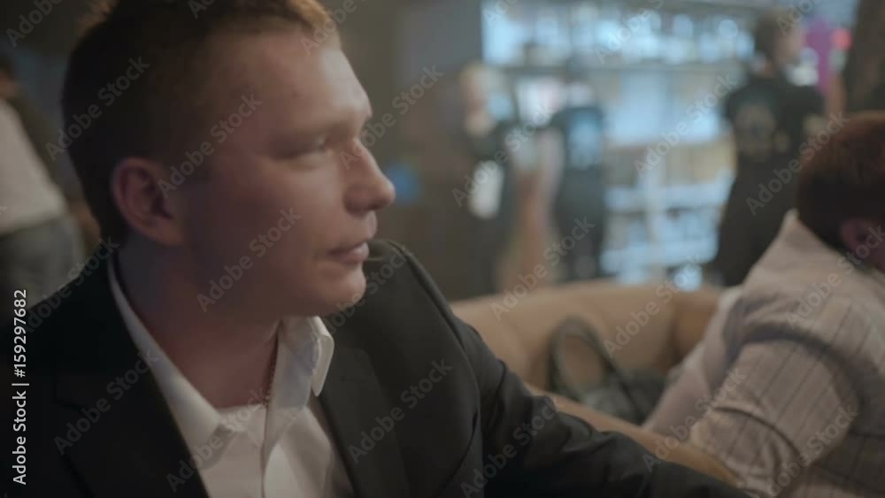 Man drinking a cocktail in a cafe close-up Man drinking a cocktail in a cafe close-up