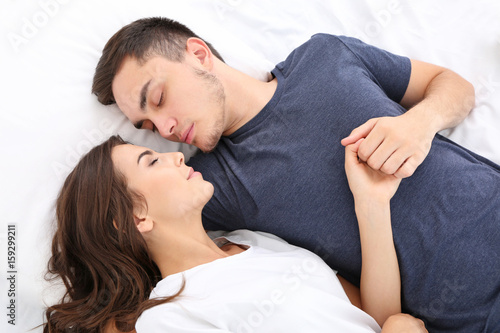 Beautiful young couple lyin...