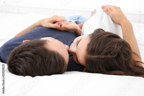 Beautiful young couple lyin...