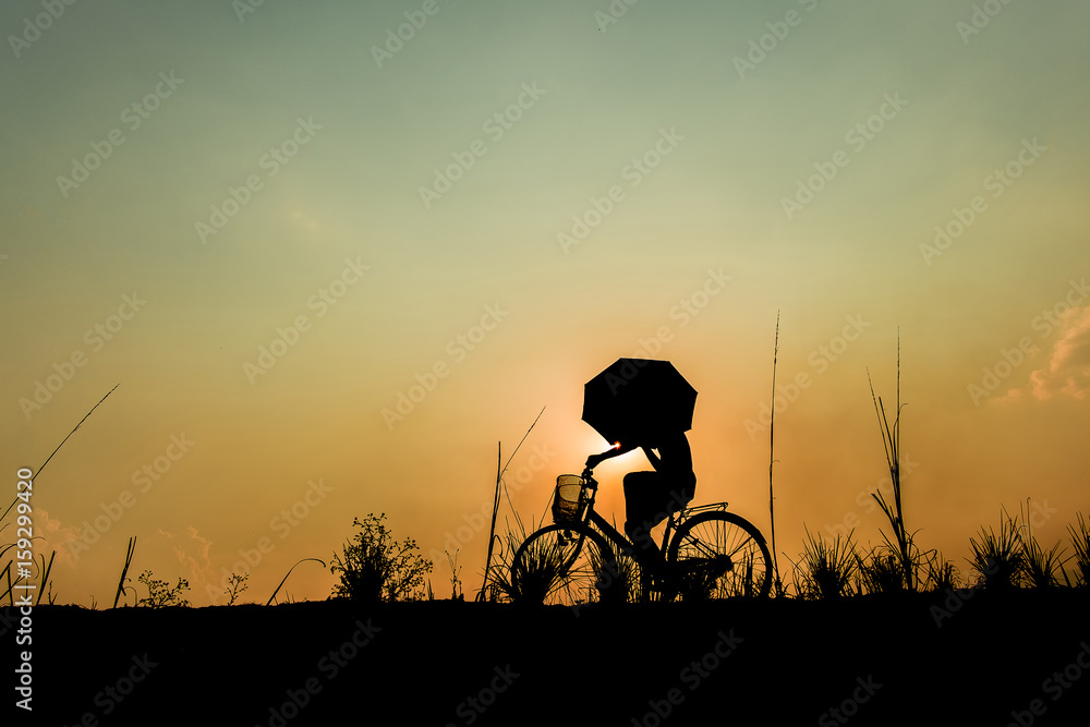 Silhouette of boy riding bicycle on sunset background. Silhouette of boy riding bicycle on sunset background.