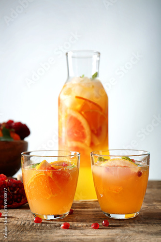 Two glasses of fresh citrus cocktail on table
