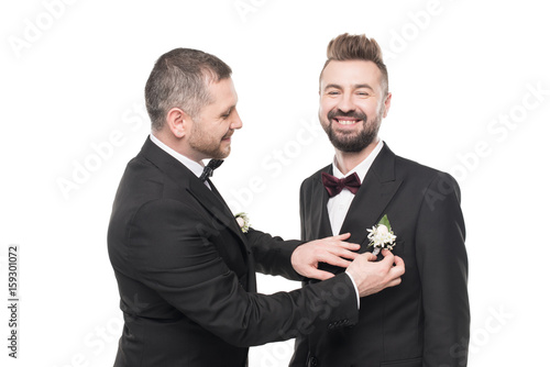 couple of grooms in tuxedos preparing to wedding day isolated on white