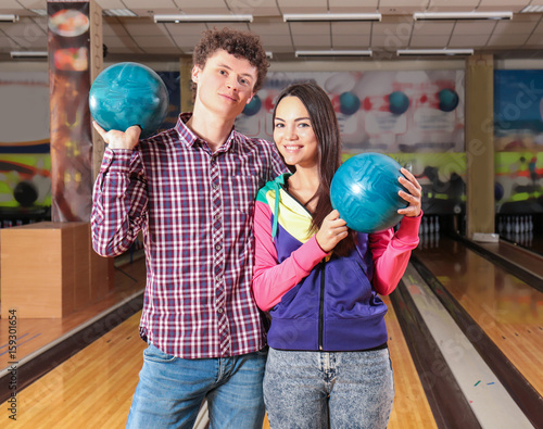 Couple having fun in bowlin...