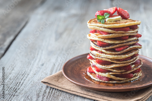 Stack of pancakes with fresh strawberries