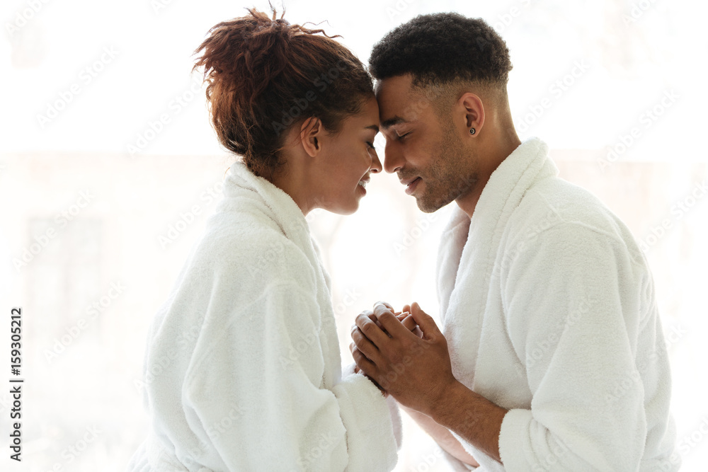 Young african loving couple standing indoors at home Young african loving couple standing indoors at home