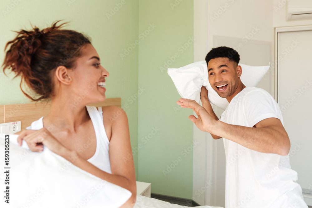 Fototapeta premium Young happy african loving couple have fun indoors