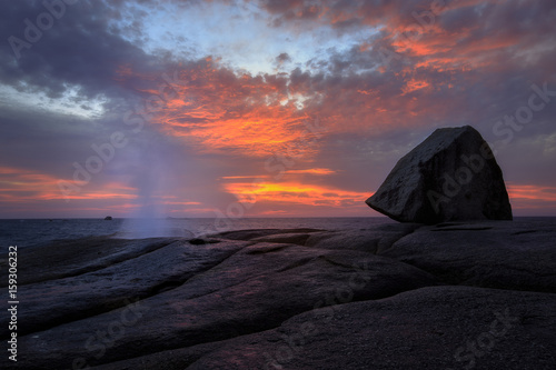 Bichino blowhole blowing at sunrise with red sky