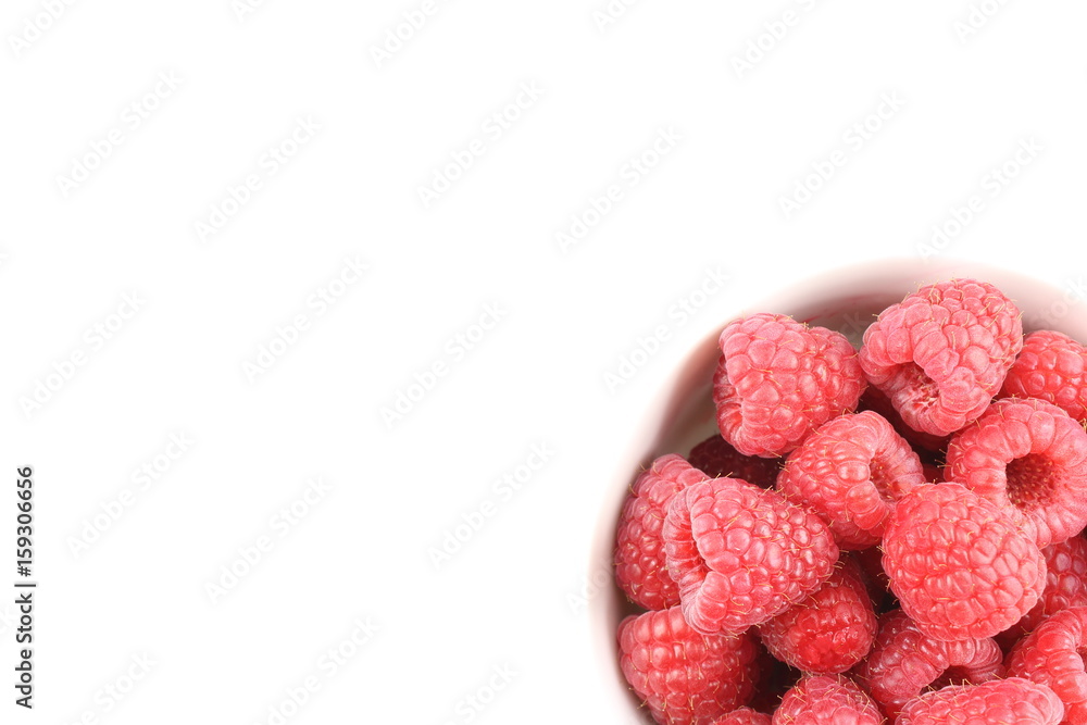 fresh red raspberry fruits in a small white bowl fresh red raspberry fruits in a small white bowl