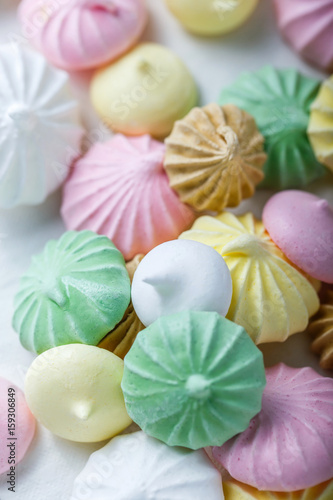 Colorful meringue cookies on napkin, natural light selective focus