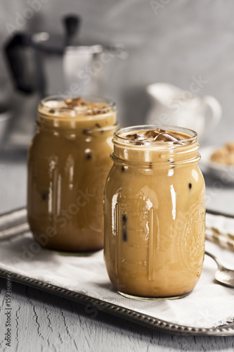 Two Iced Coffees with Milk in Glass Mason Jars