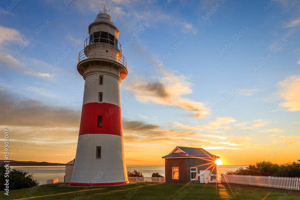 Low head lighthouse, Tasmania at sunset with sunstar
