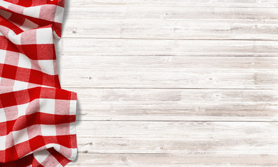 red checkered picnic tablecloth on white wood table