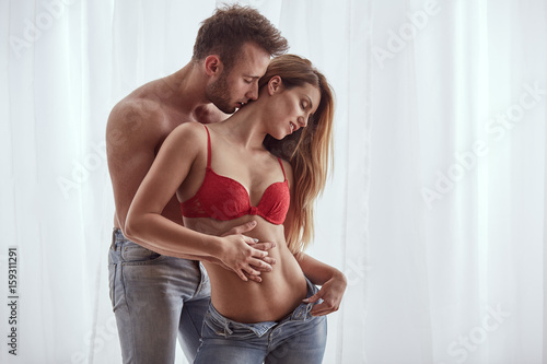 Fotografie Woman taking off her jeans