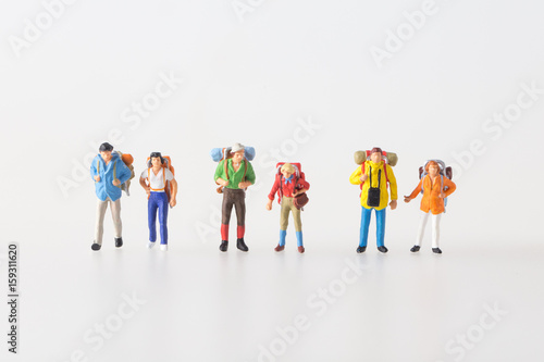 Miniature model team traveller model standing together, people travel in concept, isolatrd on white background.