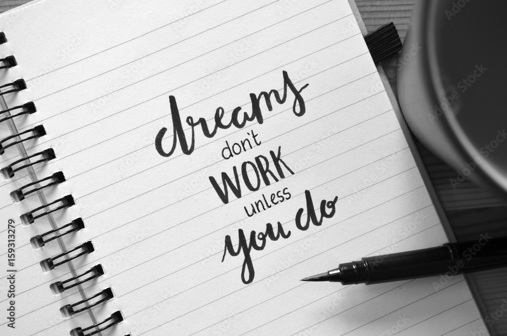 DREAMS DON’T WORK UNLESS YOU DO motivational quote written in notebook DREAMS DON’T WORK UNLESS YOU DO motivational quote written in notebook