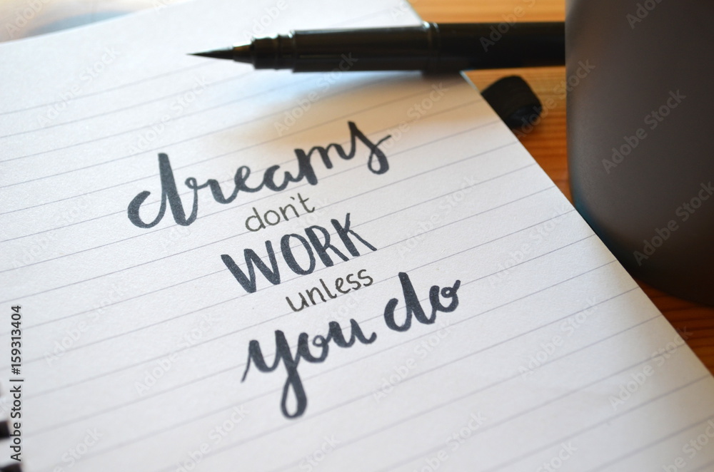 DREAMS DON’T WORK UNLESS YOU DO motivational quote written in notebook DREAMS DON’T WORK UNLESS YOU DO motivational quote written in notebook