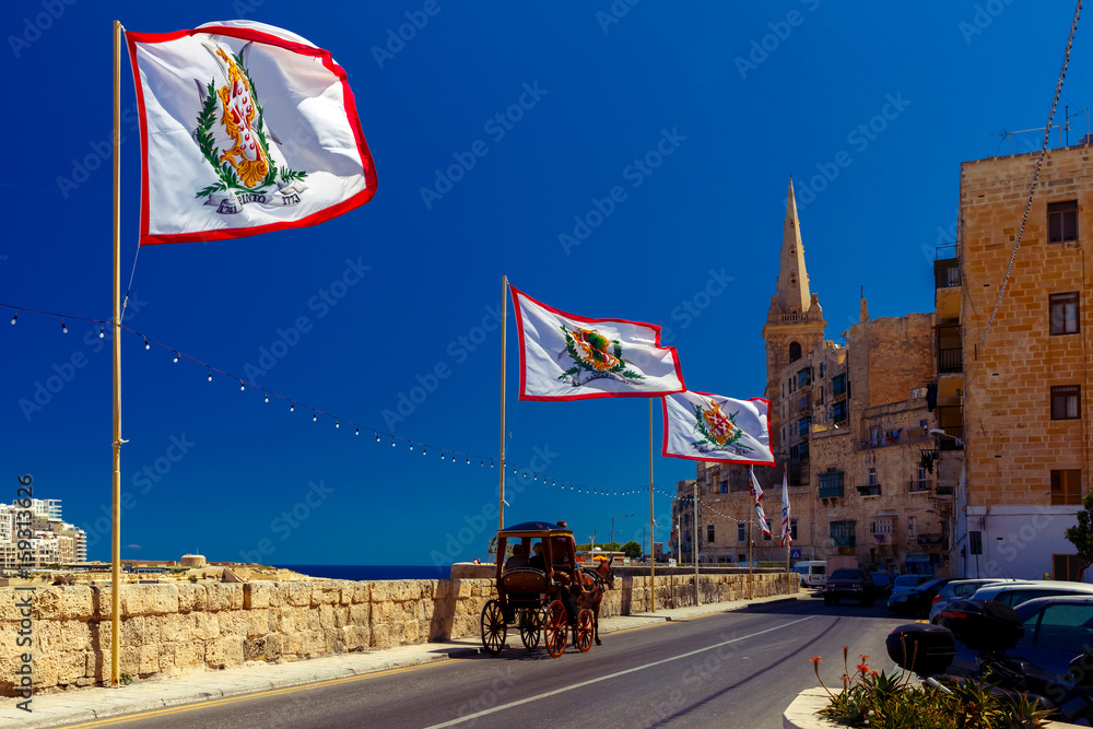 Festively decorated street with flags of all the Grand Masters of the